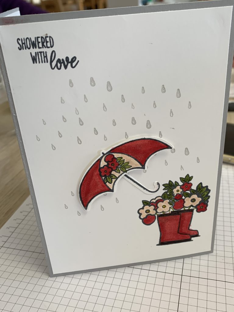 Under My Umbrella card using #simplestamping for Coffee and  Cards. This one had a rain shower, shimmery boots in Coastal Cabana with flowers tumbling out of the top.