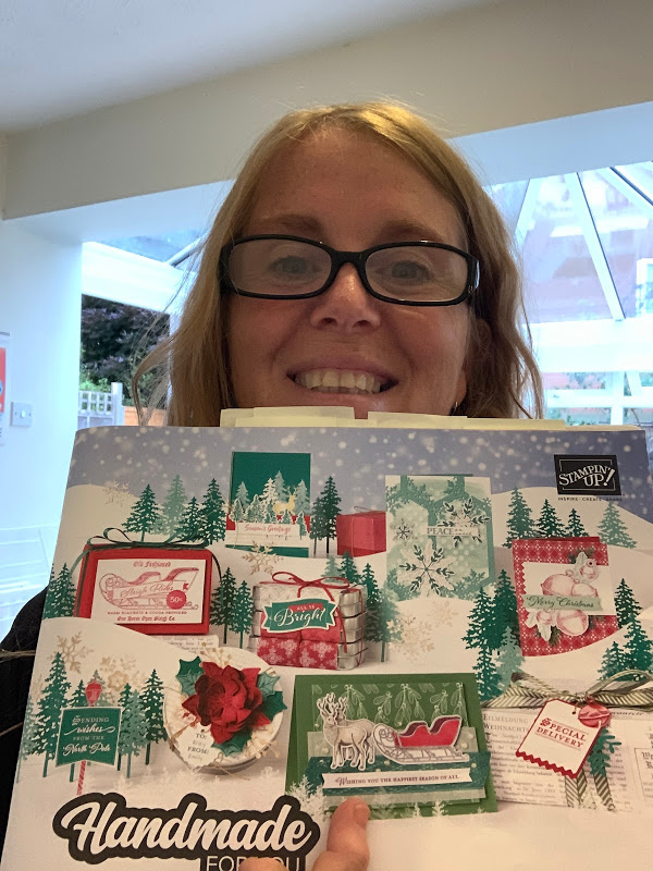 New Christmas catalogue selfie with pages marked with post it notes.